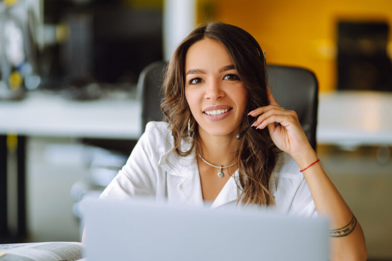 Young operator woman agent with headsets working in a call centre.